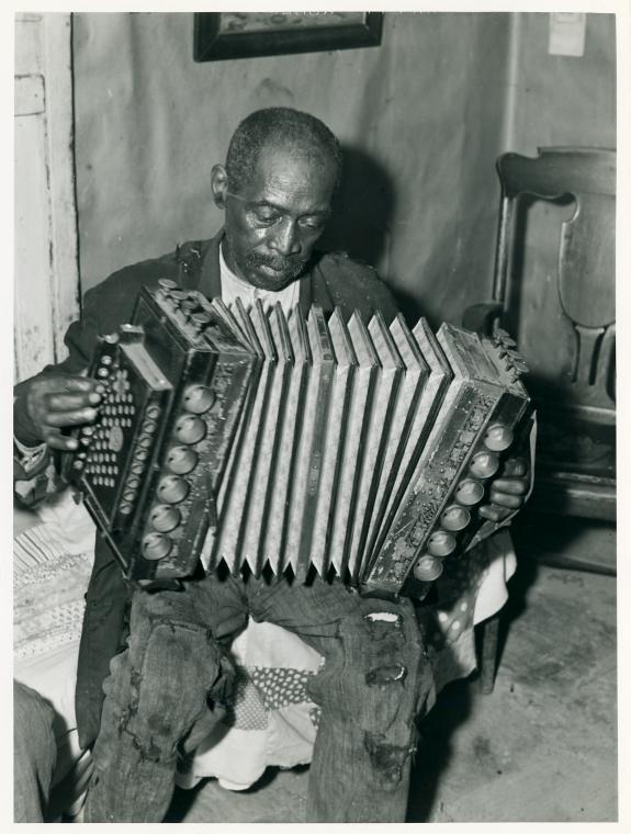 John Dyson, FSA (Farm Security Administration) borrower, playing the