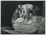 Unloading tobacco from trailer into baskets according to the grade, the night before auction sale, in warehouse. Durham, North Carolina. Nov. 1939.