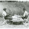 Stable hand and trainer eating picnic lunch before the Shelby County Horse Show and Fair, Shelbyville, Kentucky. Aug. 1940.
