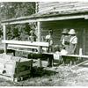 Pauline Clyburn, rehabilitation client, and her children stringing tobacco; Manning, Clarendon County, South Carolina.