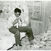 Southeast Missouri Farms. Son of a sharecropper dressing in a combination of bedroom and corn crib, 1938.