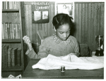 Daughter of Pomp Hall sewing in school; Sewing is her 4-H club project; Creek County, Oklahoma.