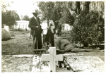 Negro couple at grave of relative; All Saint's Day in cemetery at New Roads, La.