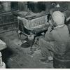 Negro boy sitting by the stove on a cold in the strawberry picking season near Independence, La. April 1939.