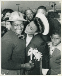 Lena Horne, African American actress, singer, and sponsor of the SS George Washington Carver, about to place a kiss on the cheek of Montrose Carrol, a chipper who worked on the Liberty ship, during the ship's launching, Richmond Shipyard No. 1