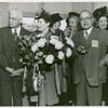 Mrs. Jessie Matthews Vann (center) holding a bouquet of flowers and flanked by C.C. Spaulding (left), president of the North Carolina Mutual Life Insurance Company, and Dr. Emmett J. Scott (right), of the Sun Shipbuilding Company, at the launching of Liberty ship SS Robert L. Vann
