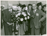 Mrs. Jessie Matthews Vann (center) holding a bouquet of flowers and flanked by C.C. Spaulding (left), president of the North Carolina Mutual Life Insurance Company, and Dr. Emmett J. Scott (right), of the Sun Shipbuilding Company, at the launching of Liberty ship SS Robert L. Vann