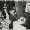 Mrs. John H. Sengstacke, sponsor of the Liberty ship SS Robert S. Abbott, christens the ship by breaking a bottle of champagne against its hull on the day of its launching, Permanente Metals Corporation Shipyard No. 2