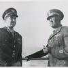 Captain James Pughsley, right, Chicago, Illinois, former adjutant with the 477th Bomber Group at Godman Field, Kentucky, is shown with Chief Warrant Officer Sylvester Trotte, left, aboard the U. S. Army Transport Algonquin enroute to the Mediterranean Theater