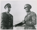 Captain James Pughsley, right, Chicago, Illinois, former adjutant with the 477th Bomber Group at Godman Field, Kentucky, is shown with Chief Warrant Officer Sylvester Trotte, left, aboard the U. S. Army Transport Algonquin enroute to the Mediterranean Theater