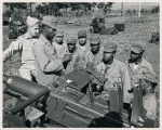 African American soldiers learning how to operate antiaircraft guns with the help of their instructor