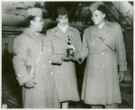 African American women basketball players holding their trophy won at the WAC Theater Basketball Championship in Rouen, France