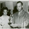 African American Sergeant Alton V. McSween pouring punch while his wife, Miss Letitia Lee Walker, employee of the Del Monte Avenue USO Club, looks on