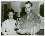 African American Sergeant Alton V. McSween pouring punch while his wife, Miss Letitia Lee Walker, employee of the Del Monte Avenue USO Club, looks on