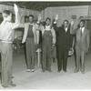 Induction station officer swearing in African American fathers and sons