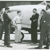A white P-80 pilot standing next to a plane and speaking to African American Marcus H. Ray, Civilian Aide to the Secretary of War, as four other African American men look on and listen, Army Air Forces Wright Field, Dayton, Ohio