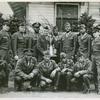 Group portrait of members of the Camp Lee boxing team, mostly African American, posing with Commanding General of the Post, Brigadier General R. C. L. Graham (holding trophy), Camp Lee, Virginia