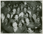A crowd of African American Women's Army Corps members waving at the camera, Staten Island Terminal, New York Port of Embarkation