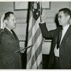 An African American man, Edward Swain Hope of Washington, D. C., is sworn in as a Lieutenant, CEC-V(S),  USNR at Washington, D.C. by Lieutenant Commander H.B. Atkinson, USNR, Executive Officer of the Office of Naval Officer Procurement of Washington