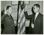 An African American man, Edward Swain Hope of Washington, D. C., is sworn in as a Lieutenant, CEC-V(S),  USNR at Washington, D.C. by Lieutenant Commander H.B. Atkinson, USNR, Executive Officer of the Office of Naval Officer Procurement of Washington