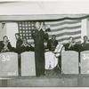 Group portrait of African Americans, Seabee Band members, from the 30th Special U.S. Naval Construction Battalion, playing on a stage