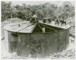 U.S. Navy African American Seabees covering a steel tank, South Pacific bases