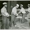 U.S. Navy African American enlisted members placing six-inches-shells in magazines at the Naval Ammunition base