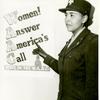 African American Charity Adams, First Officer in the Women's Army Auxiliary Corps, standing in uniform and pointing to a poster that reads, "Women! Answer America's Call, Serve in the W.A.A.C."