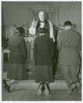An Episcopal Bishop confirming African American Lieutenants Rosemary Vincent and Hallie M. Brown and an unidentified soldier, as they kneel before him