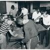 Six young men assembling metal screens in three teams of two