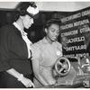 Young woman demonstrating equipment for Mrs. Edith Alexander