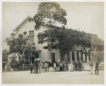 Men and women gathered in downtown in their dress clothing.