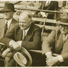Herbert Hoover sitting in outdoor stands.
