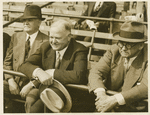 Herbert Hoover sitting in outdoor stands.