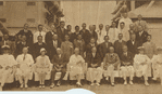 Herbert Hoover on seated with others on the deck of a warship.