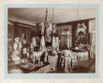 Large room with displays of embroidery towels, tableclothes, pillow cases, costumes, dolls and napkins, etc.