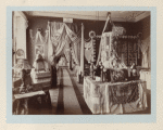 General view of the exhibition, featuring tablecloths and dolls in different costumes, even a lamp with laces lampshades