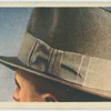Why has a man's hat a bow tied in the ribbon on the left side?