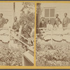 Group of African American women and men on the porch of a house.