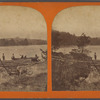 View on the shore, group getting into a small boat.
