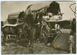 Woman and children in a covered wagon.