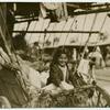 Girl in a covered wagon, smiling.