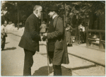 Paul Ruffy in conversation with an unidentified man.