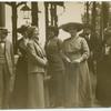 Women standing on a street corner.