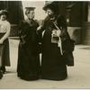 Two women in conversation on the street.