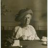 Unidentified woman having tea.
