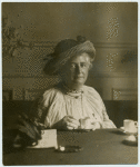 Unidentified woman having tea.