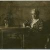 Carrie Chapman Catt, writing at a table.