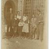 Group portrait in front of house.