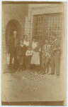 Group portrait in front of house.